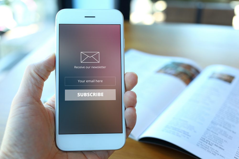 Hand,Holding,Smartphone,With,Receive,Newsletter,Form,Screen,On,Cafe Hand,Holding,Smartphone,With,Receive,Newsletter,Form,Screen,On,Cafe
