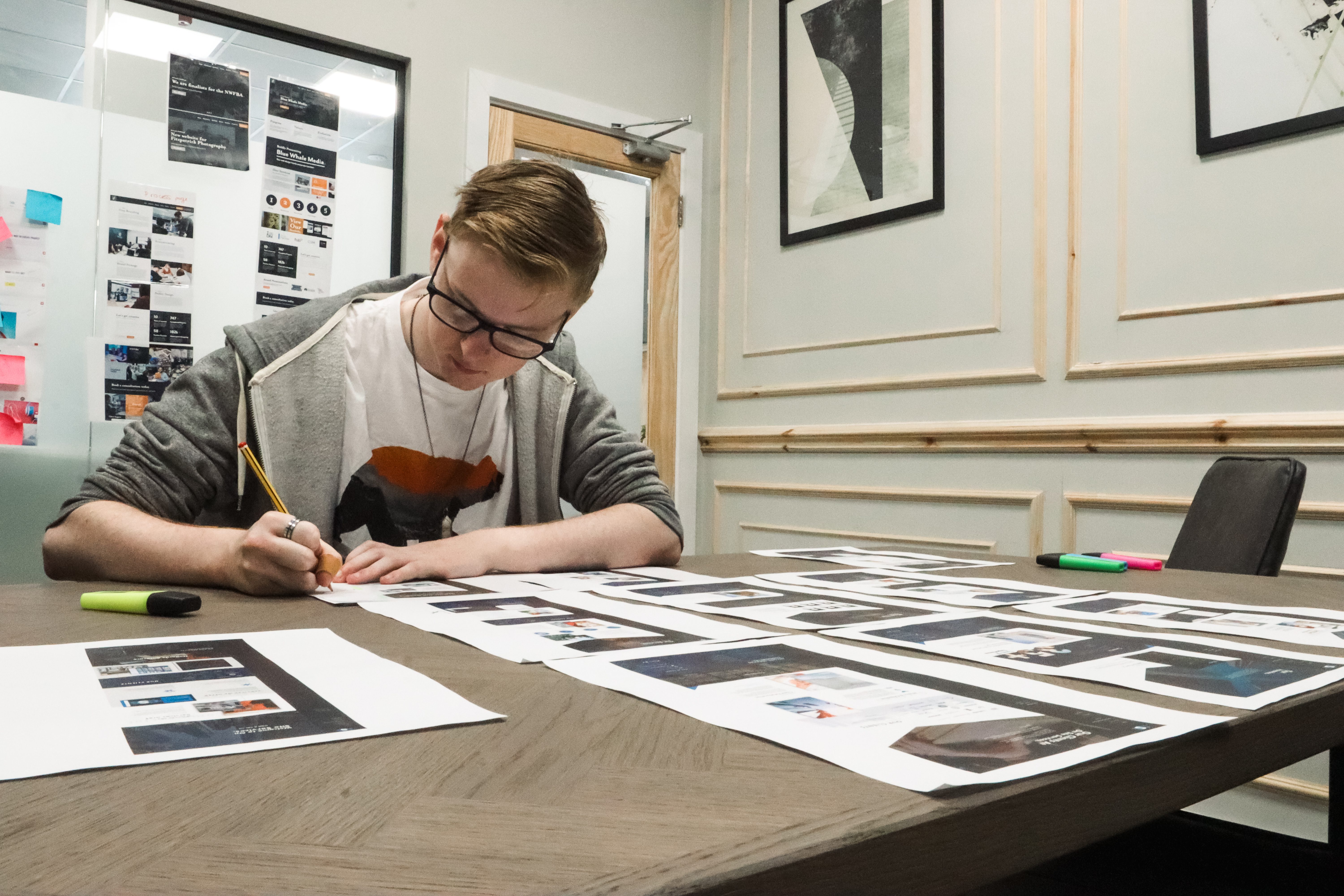 website designer sat at desk reviewing website designs