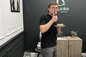 Alex Whitehouse enjoying some cake at Blue Whale Media's MacMillan bake sale 2022.