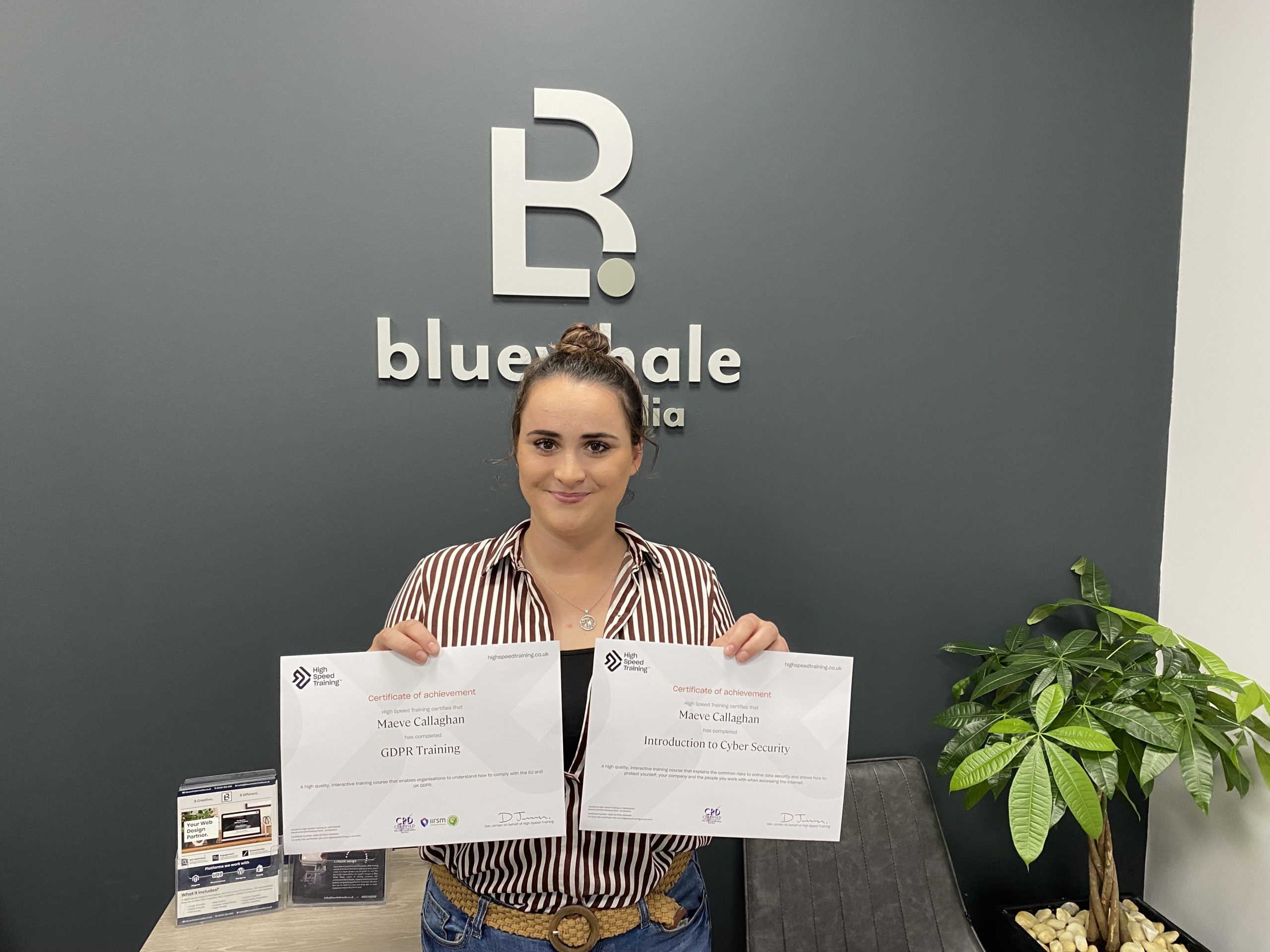 Maeve Callaghan with two certificates for passing GDPR course and Cyber Security course