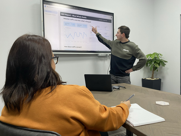 Jamie Smith and Danielle Whittaker in a meeting room, discussing a website SEO report.