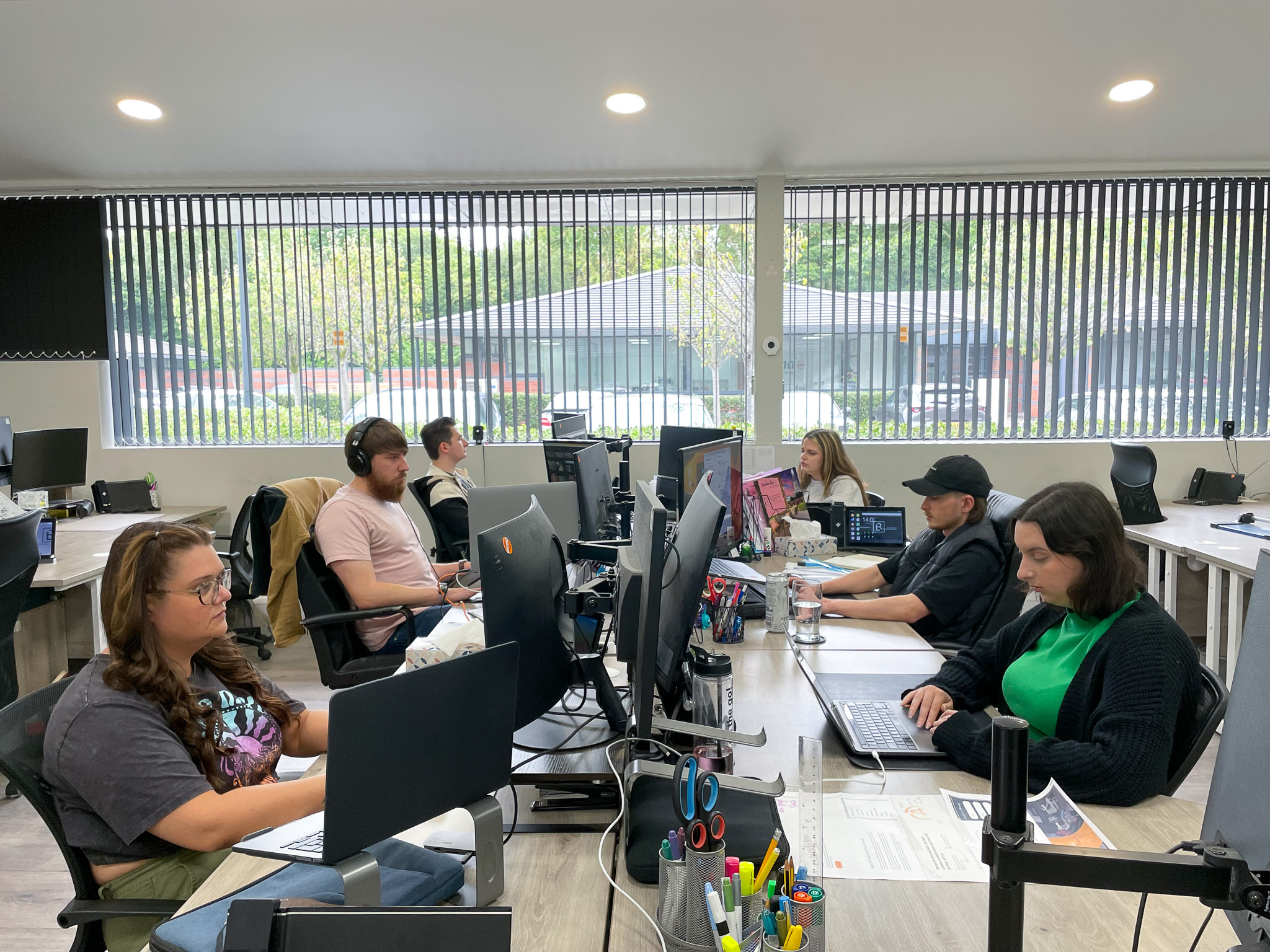 Photograph of Blue Whale Media staff working in-office. Visible in the photograph are: Molly Bailey, Alex Whitehouse, Jessica Thornton, Danielle Whittaker, Anthony Trantum and Jamie Smith